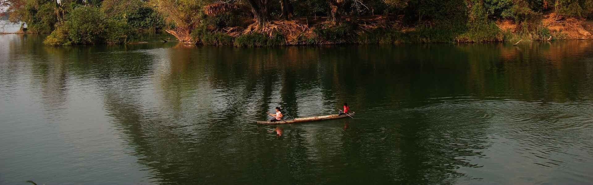 Lush greenery of Don Khong in Laos for a vibrant Don Khong Tours banner with Legend Travel Group.